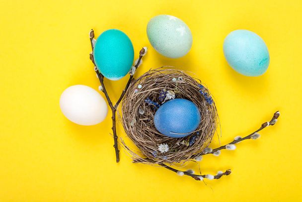 Colorful background with Easter eggs on yellow background. Happy Easter concept. Can be used as poster, background, holiday card. Studio Photo - Photo, Image