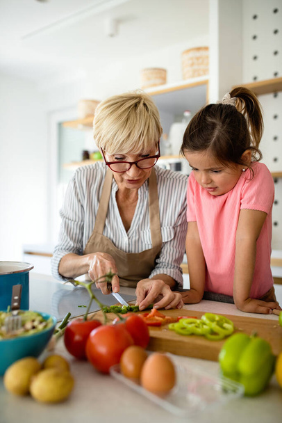 Family fun love generation concept. Grandmother and granddaughter are cooking on kitchen. - Foto, Bild