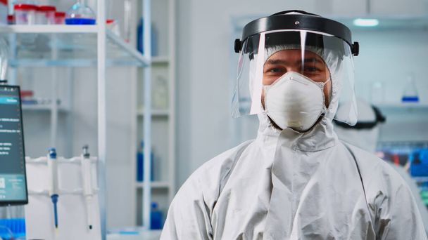 Scientist man wearing coverall smiling at camera - Photo, Image