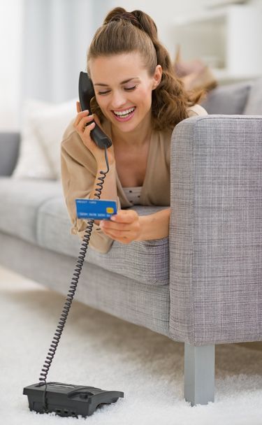 Woman with credit card  talking phone - Fotó, kép