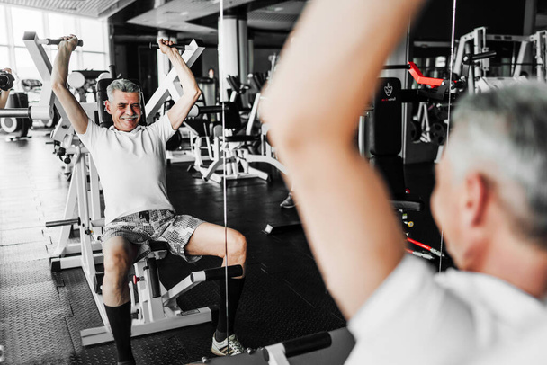 Sport. Photo of a senior man in the gym during a workout. Healthy Lifestyle. - Valokuva, kuva