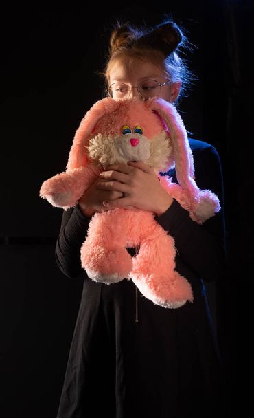 Girl with a big plush hare. Girl teenager with a pink hare. Girl with a gift. - Photo, Image