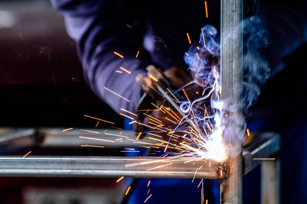 welder and welding sparks, construction and metal work industrial concept, metal welding with sparks, laborer or labor day concept - Φωτογραφία, εικόνα
