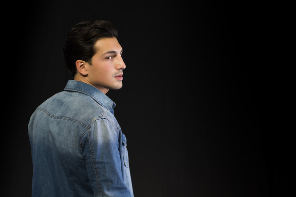 Young man wearing denim shirt seen from the back, looking to a side - Fotó, kép