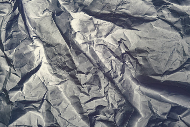 Gray crumpled shiny abstract paper background - 写真・画像