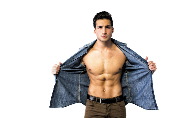 Latin young man opening denim shirt on naked chest - Foto, afbeelding