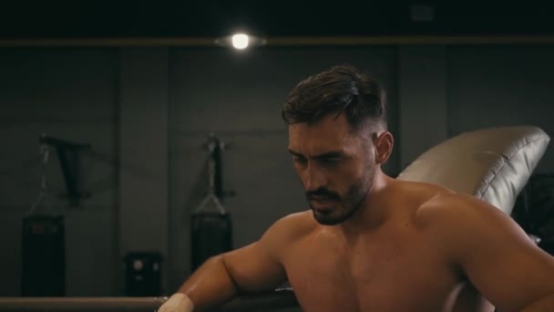 tired hispanic fighter with boxing tape on hands wiping sweat - Záběry, video