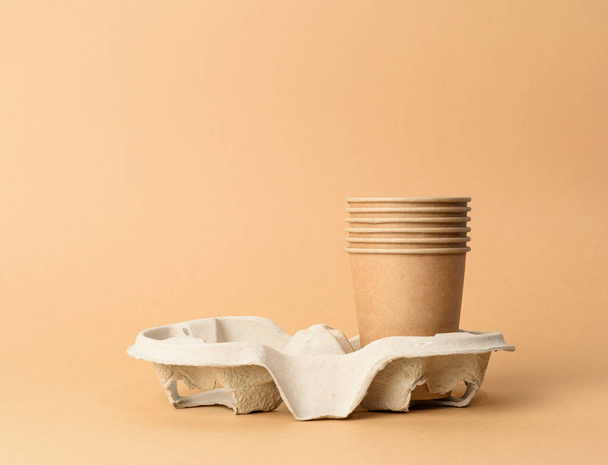 brown disposable cups in paper holder on blue background, rejection of plastic, zero waste - Photo, Image
