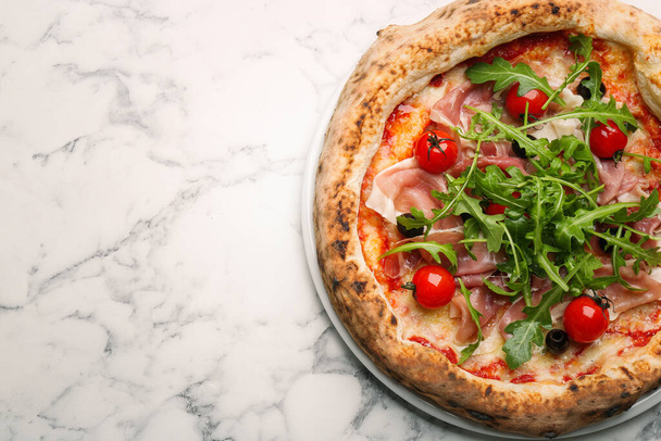 Tasty pizza with meat and arugula on white marble table, top view. Space for text - Fotografie, Obrázek