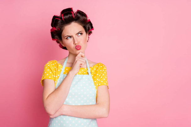 Portrait of pensive girl look copyspace think wear retro clothes hair curlers isolated on pastel color background - Foto, afbeelding