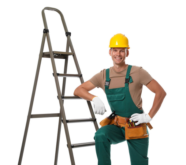 Professional constructor near ladder on white background - Φωτογραφία, εικόνα