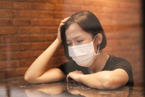 Asian women and face mask felling headeach - Fotó, kép