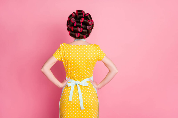 Back rear spine view photo of woman with hair curlers stand back put hands waist isolated over pastel color background - Φωτογραφία, εικόνα