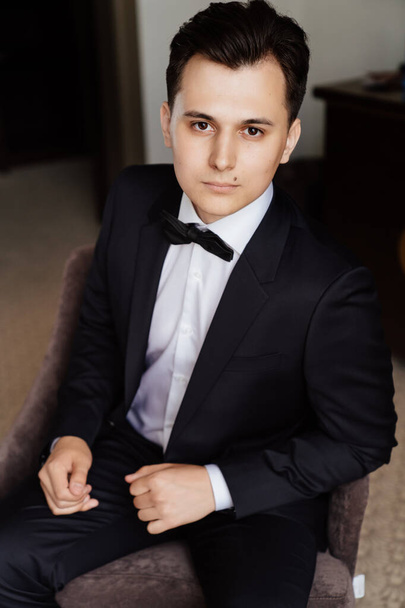  young man in white shirt, bow tie and a black jacket . - Fotografie, Obrázek