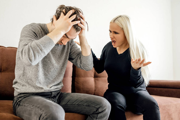 upset thoughtful husband thinking about relationship problems, wife ignoring after quarrel, angry man and woman not talking, sitting separately on couch, family crisis conflict concept - 写真・画像