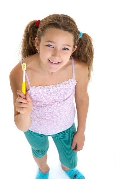 Smiling girl standing with toothbrush - Фото, зображення