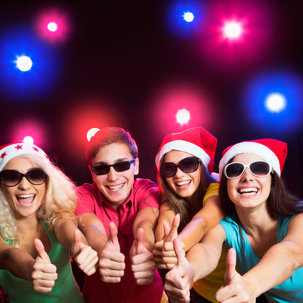 Happy people in Santa hats - Foto, afbeelding