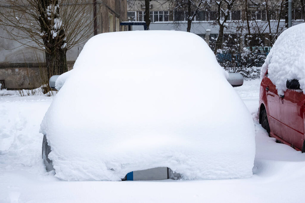 Car under thick blanket of snow after storm. Vehicles buried under ice. Nobody - Photo, Image