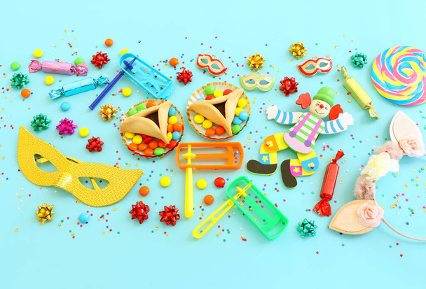 Purim celebration concept (jewish carnival holiday) over blue background. Top view, flat lay - Foto, Imagen