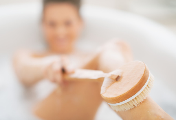 Woman in bathtub using body brush - Zdjęcie, obraz