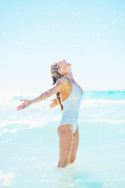 Happy woman at seaside rejoicing - Valokuva, kuva
