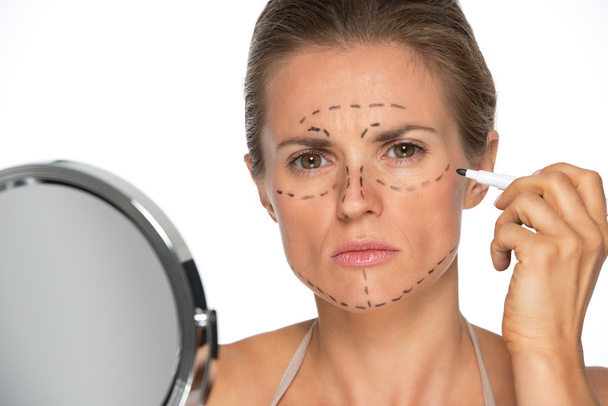 Woman applying plastic surgery marks - Φωτογραφία, εικόνα
