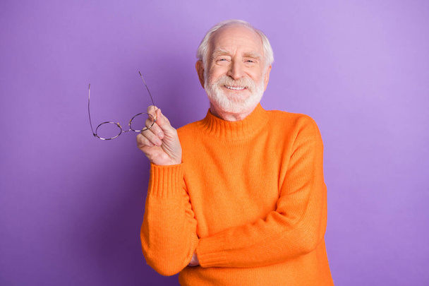 Portrait of positive man hand hold glasses toothy smile wear pullover isolated on purple color background - Φωτογραφία, εικόνα