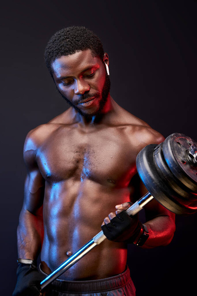 african athletic young man lifting weights - Фото, зображення