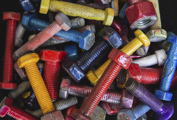 background of bolts with nuts painted in different colors - Photo, Image