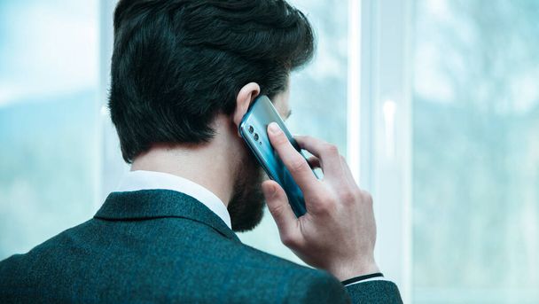 man talking in phone in window backgroun - Fotoğraf, Görsel