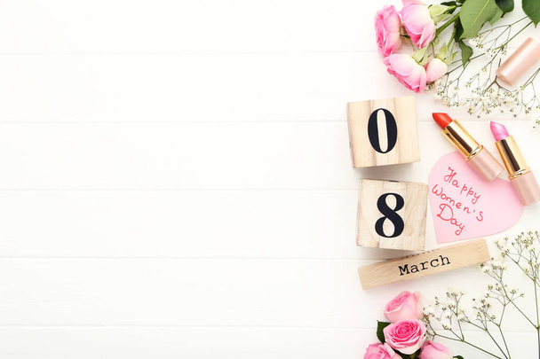 Wooden calendar with text Happy Womens Day, flowers and lipsticks on white background - Φωτογραφία, εικόνα