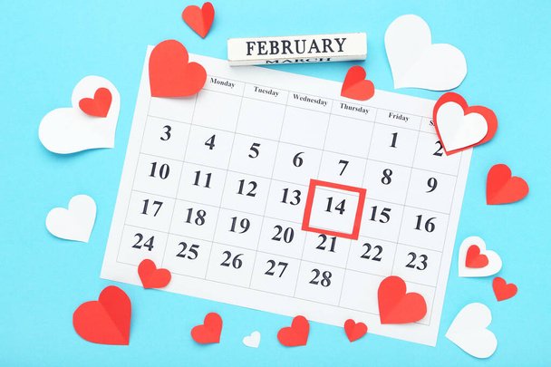 February calendar with paper hearts on blue background - Photo, Image