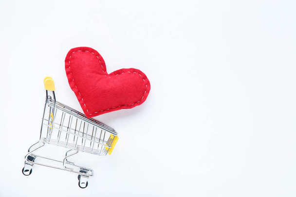 Fabric heart with shopping cart on white background - Fotoğraf, Görsel