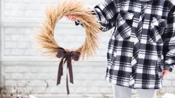 Girl holding a wreath of dried flowers in her hands - Footage, Video