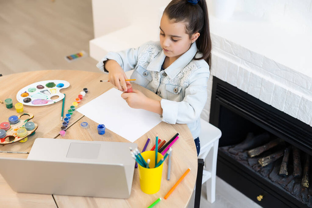 Ciddi küçük kız el yazısı çalışması evde dizüstü bilgisayar kullanarak, şirin mutlu küçük çocuk İnternet dersi ya da ders alıyor. - Fotoğraf, Görsel
