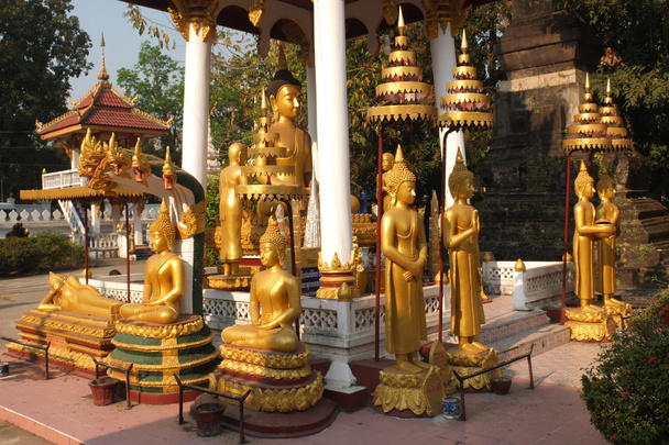 Golden statues in the garden of the Vat Si Saket - Photo, Image
