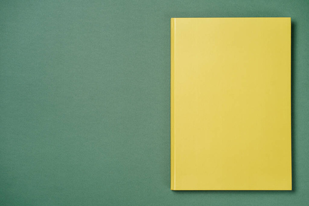 Green leather notebook on a green background - Photo, image