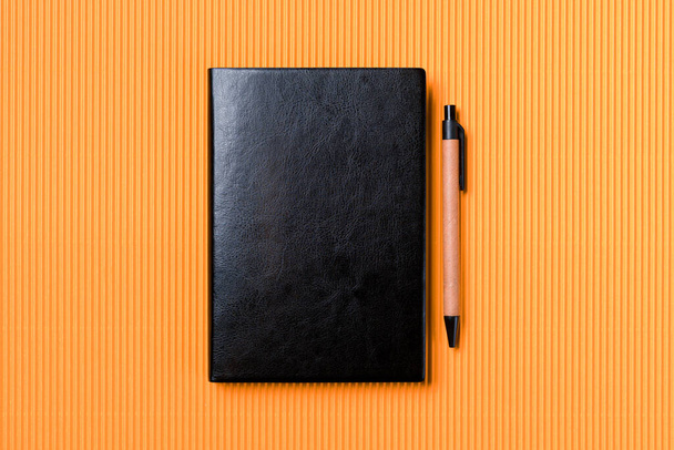 Leather notebook cover on a orange background - Foto, Bild