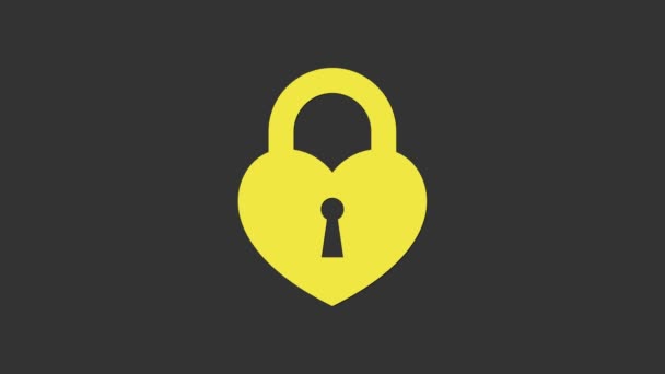 Žlutý hrad ve tvaru srdce ikony izolované na šedém pozadí. Zamčené srdce. Symbol lásky a znak klíčové dírky. Grafická animace pohybu videa 4K - Záběry, video