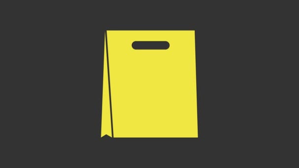 Ikona nákupní tašky ze žlutého papíru izolovaná na šedém pozadí. Značka balíčku. Grafická animace pohybu videa 4K - Záběry, video
