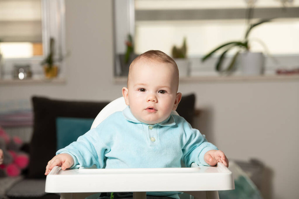 Little Baby Boy Sit on a Chair and Ready to Eat and Looking for Mom - Fotoğraf, Görsel