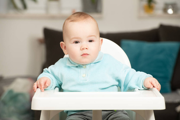 Portrait of Adorable Infant Baby Boy Sitting on the Chair - Fotó, kép