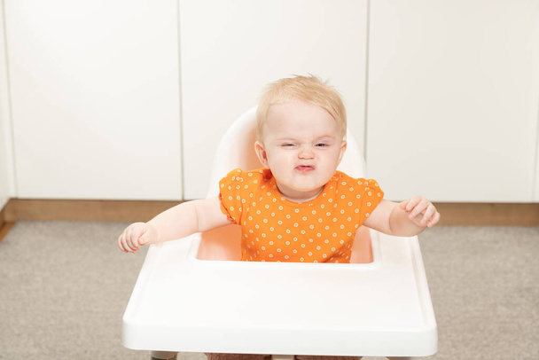 Little Baby Girl Sit on a Chair and Ready to Eat and Looking for Mom - Photo, Image