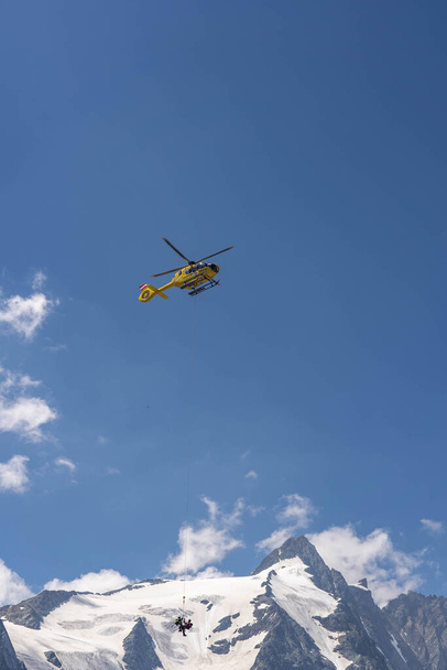Grossglockner, Austria - Aug 8, 2020: Emergency helicopter rescue ski accident in the mountain - Fotó, kép