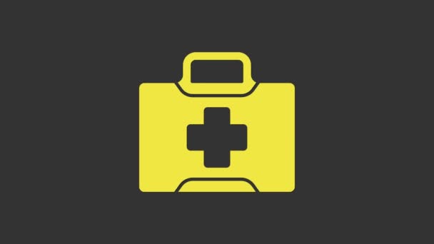 Geel pictogram EHBO kit geïsoleerd op grijze achtergrond. Medische doos met kruis. Medische apparatuur voor noodgevallen. Gezondheidszorg concept. 4K Video motion grafische animatie - Video