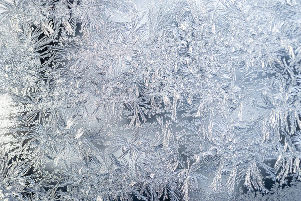 The texture of the glass covered with frost in winter in cold weather. Abstract natural background. - Photo, Image