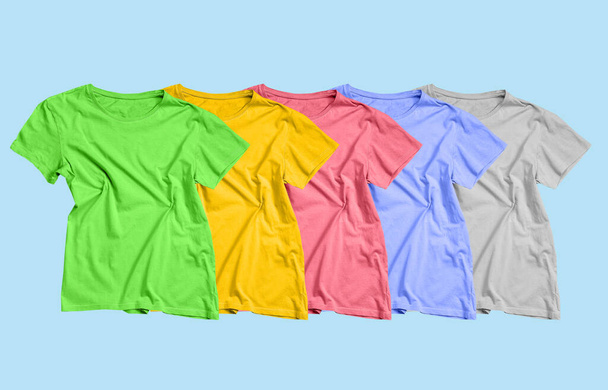 Collection of bright t-shirts on color background - Fotó, kép