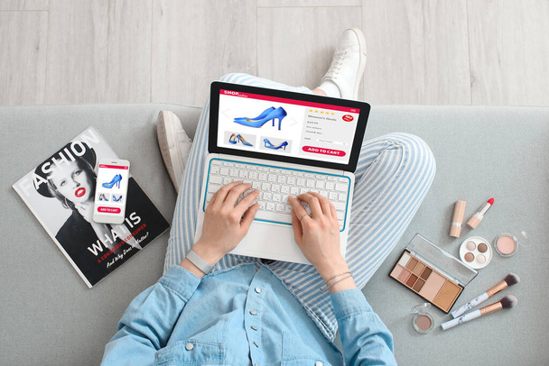 Young woman buying new shoes online at home, top view - Φωτογραφία, εικόνα