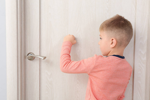 Cute little boy knocking at the door - Photo, Image