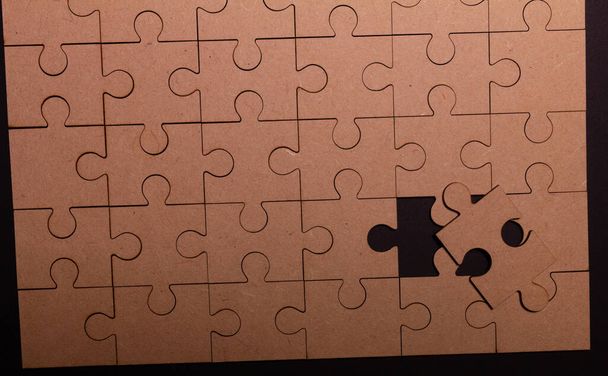 Picture of a puzzle with one piece missing. - Foto, Imagen